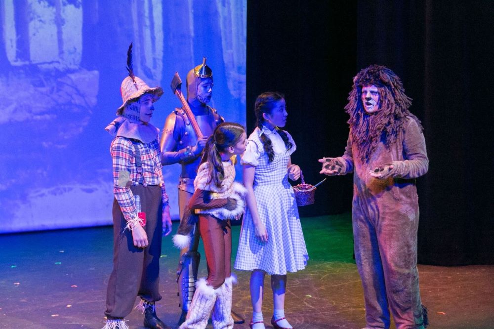 Dorothy, the Tin Man, the Scarecrow, and Toto meet the Lion